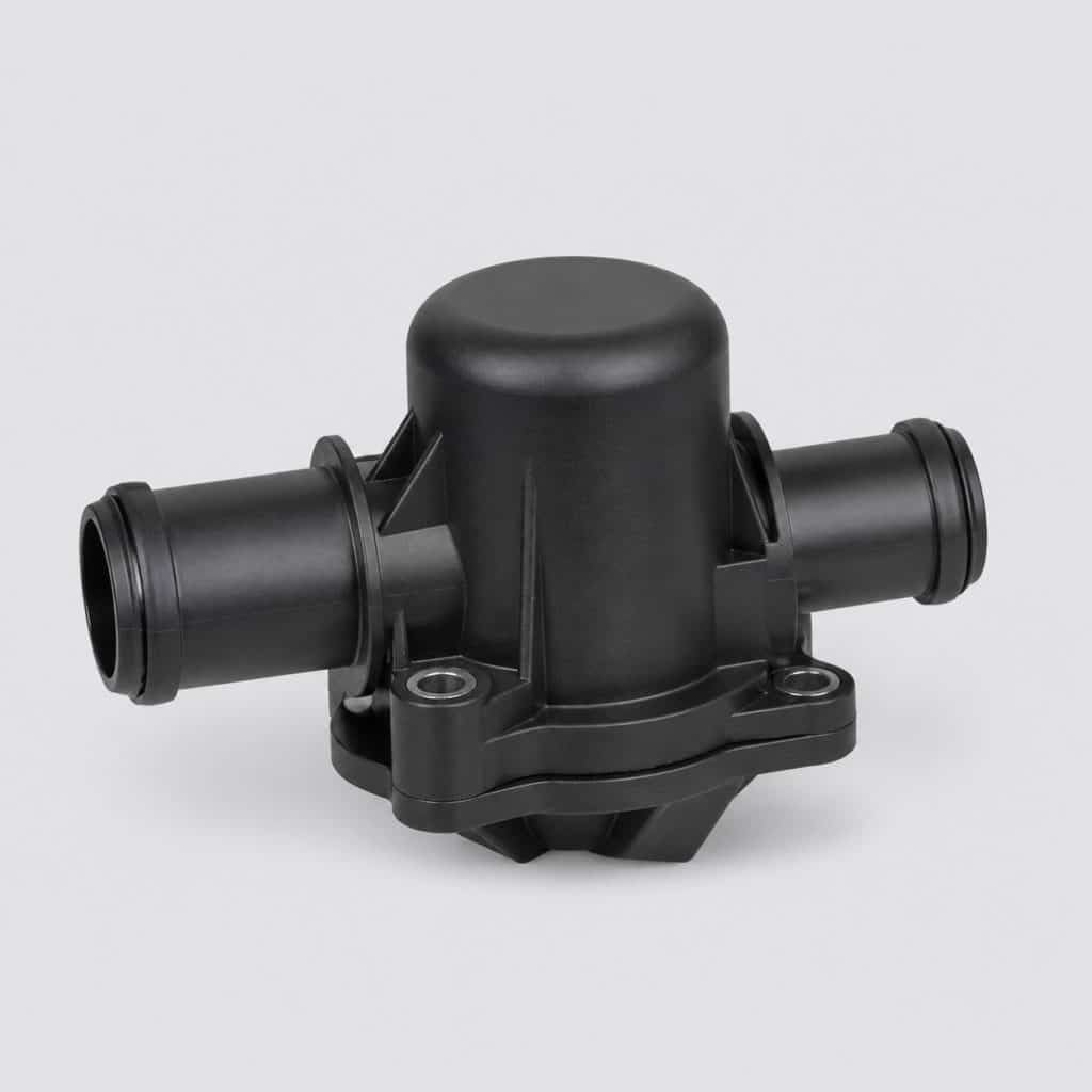 Boîtier de thermostat automobile présenté seul sur fond neutre